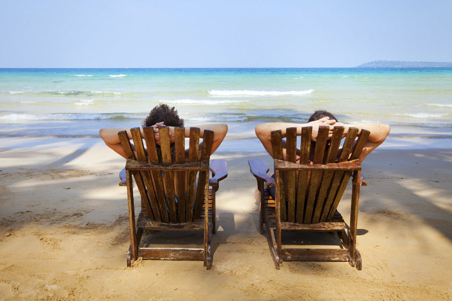 Couple sitting in chairs relaxing on the beach