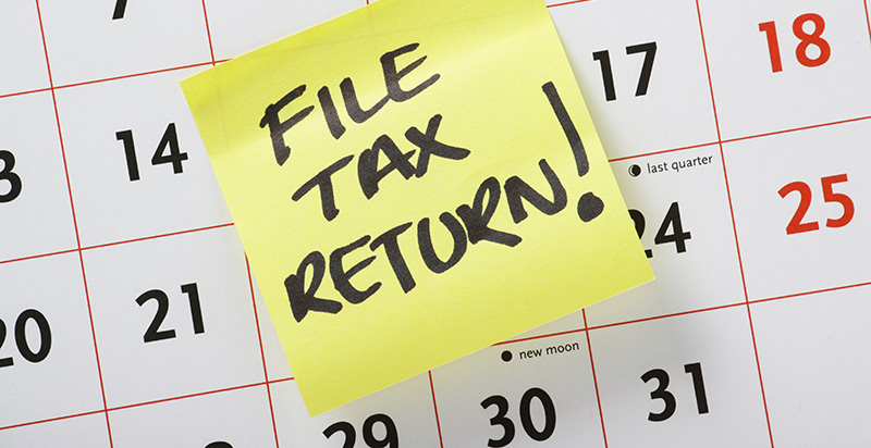 File Tax Return! written on a sticky-note