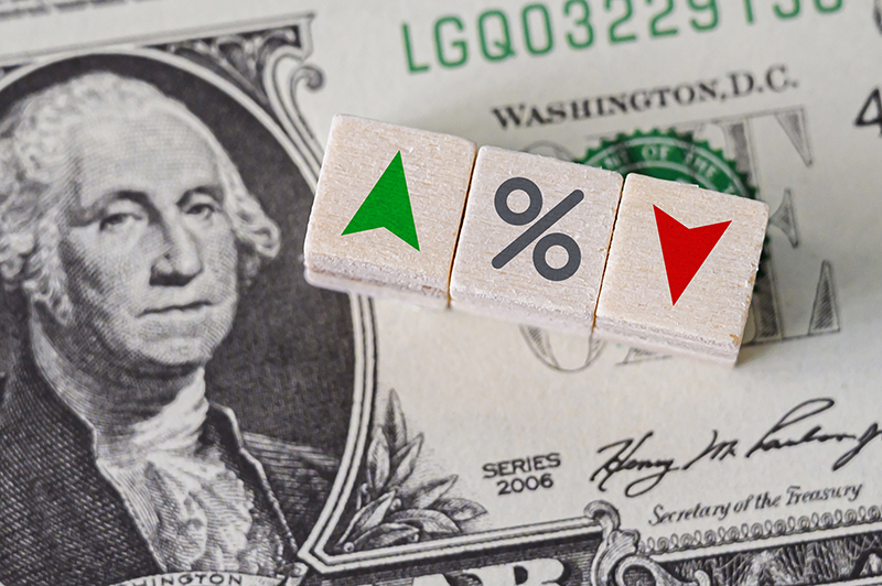 Percentage sign with dollar bill in the background