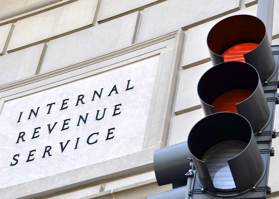 Internal Revenue Service building with traffic signal in front displaying a red light