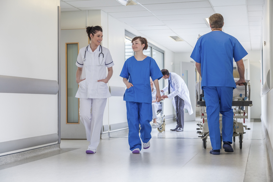 Doctors and nurses walking down hospital hallway