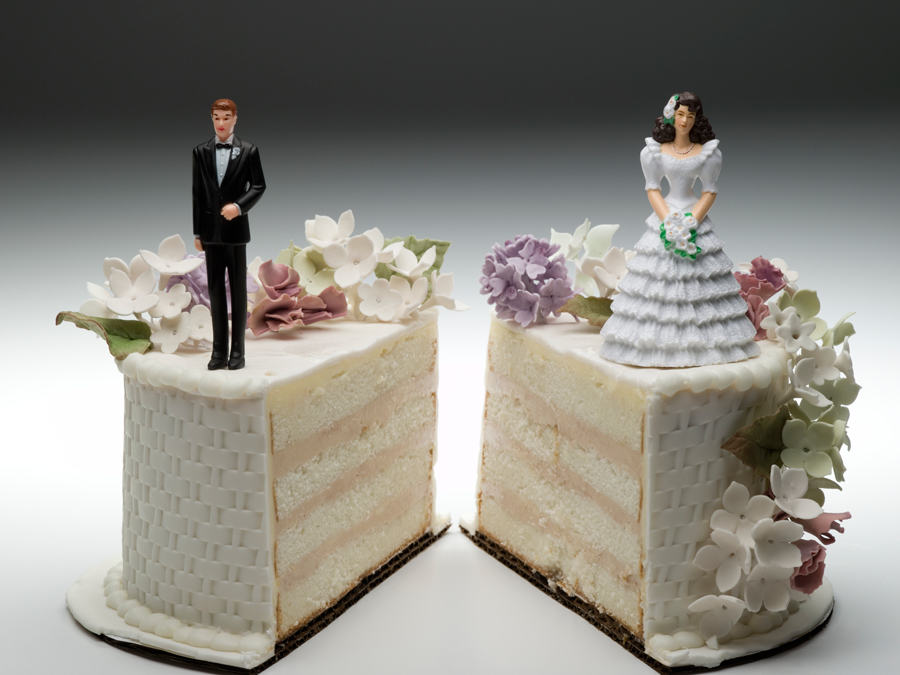 Divided wedding cake with groom on one side and the bride on the other