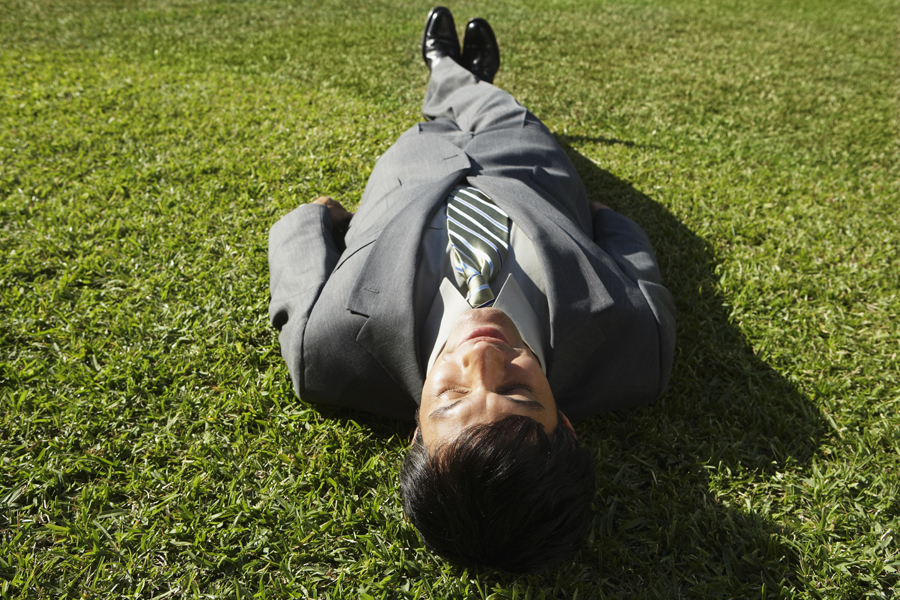 man laying on grass relaxed