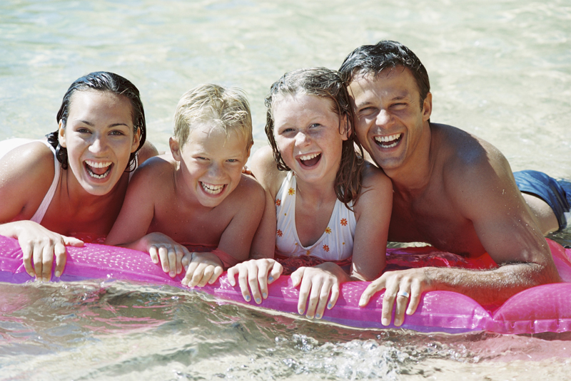 Family in swimming pool on a raft