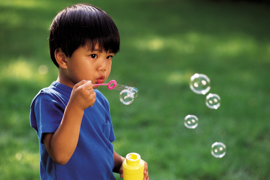 Little boy blowing bubbles