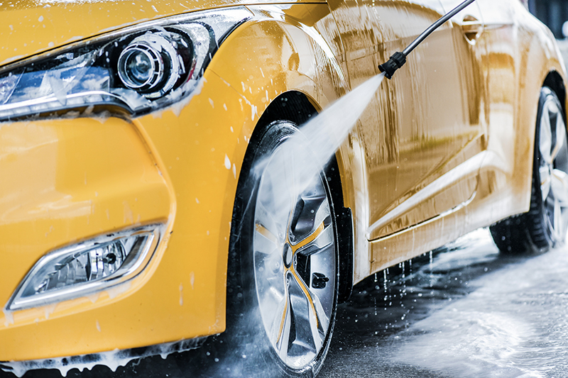 yellow car being washed