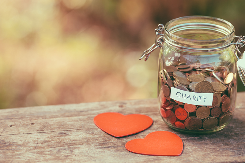 Jar with coins in it that says charity