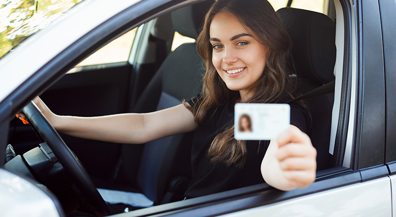 Woman Holding Up Driver's  License