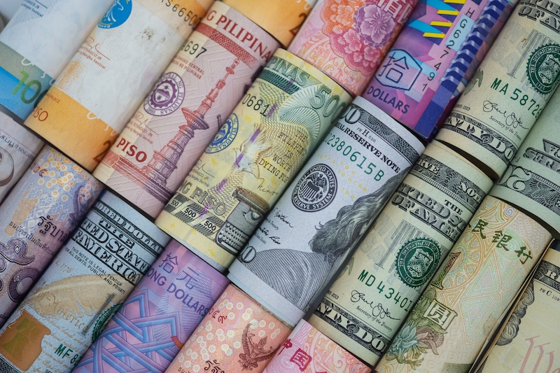 Variety of rolled banknotes from around the world