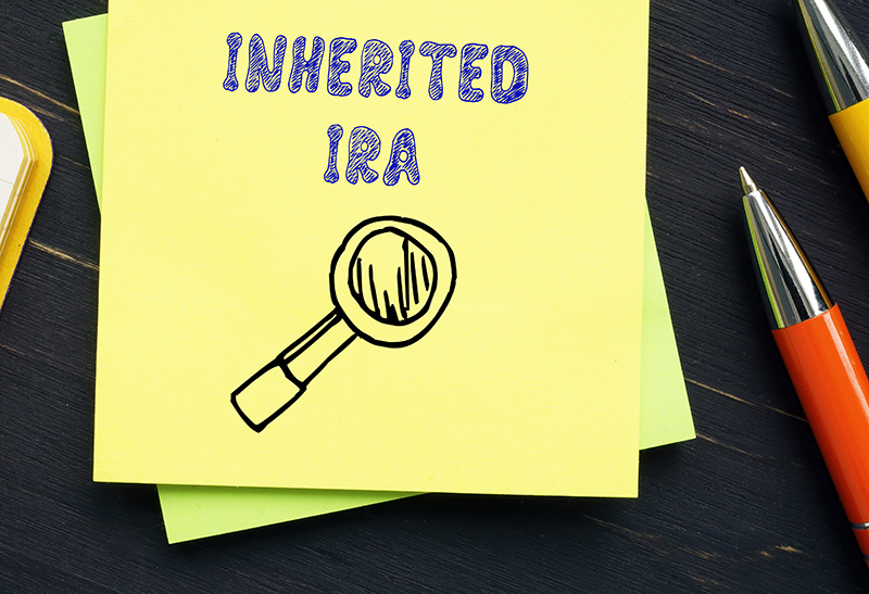 Inherited IRA written on a yellow sticky note