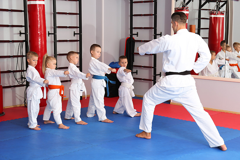 Karate teacher teaching a small class of children