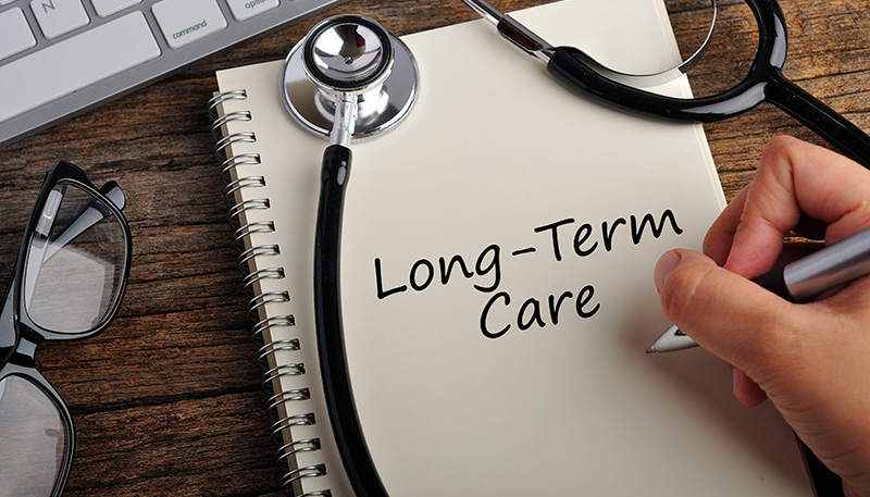 Long-Term Care written on a notebook