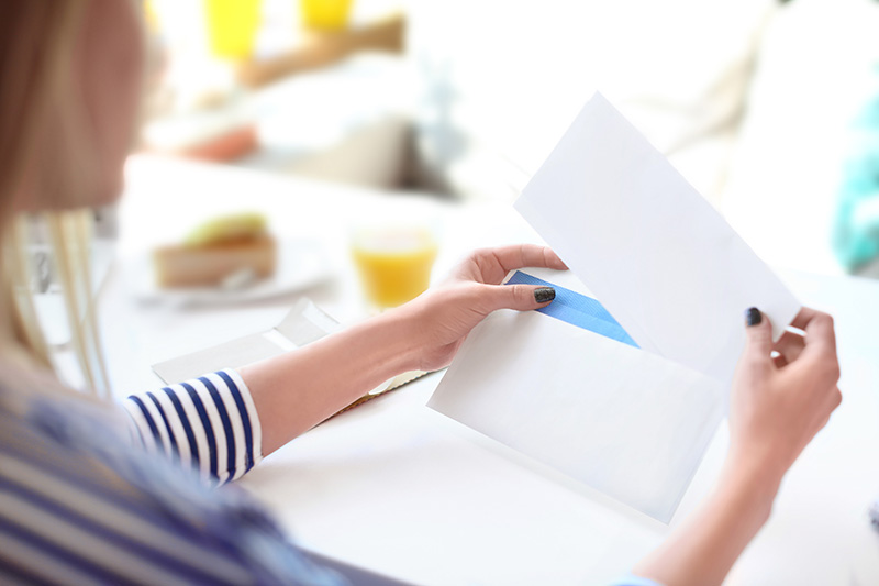 Woman opening letter