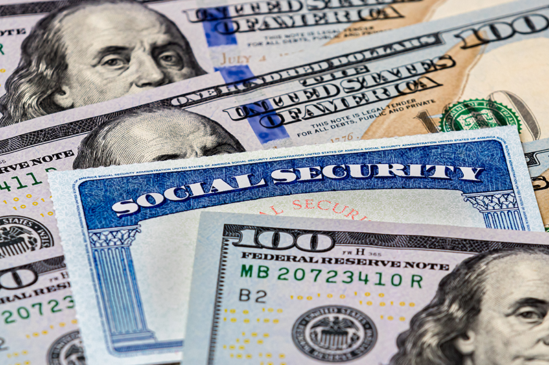 Social Security care with $100 bills