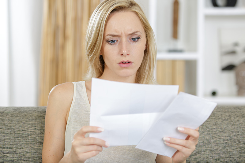 concerned woman looking at letter