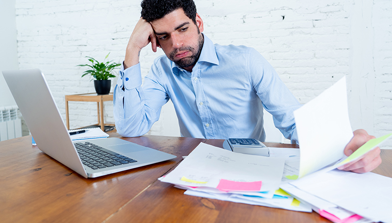 distressed business owner looking at paperwork