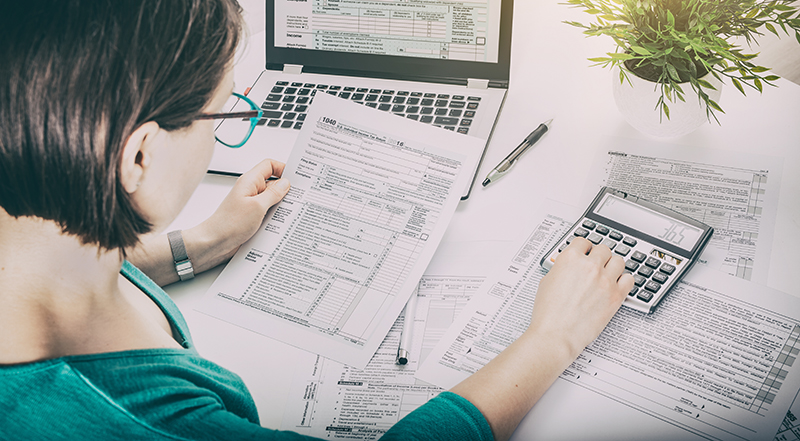 woman looking tax paperwork