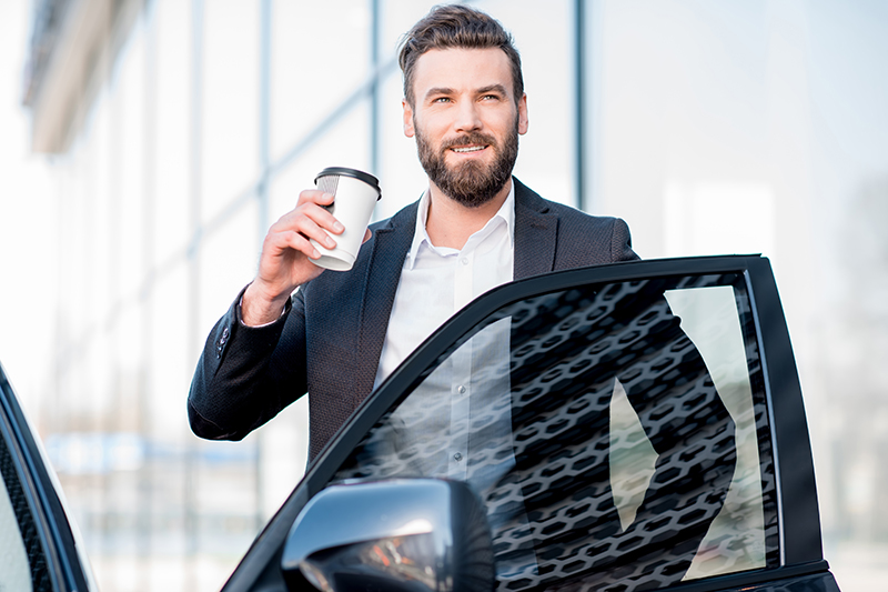 Man Drinking Coffee by Car