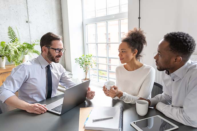 Couple discussing tax debt relief approach with an expert