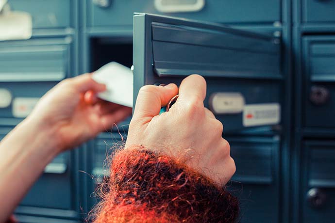 Woman opening mailbox