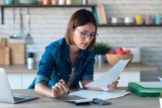 Self-employed woman considering tax bill