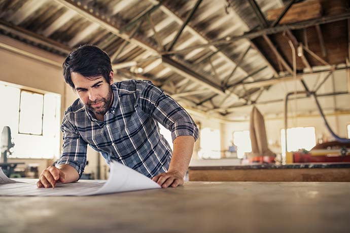 Self-employed man looking at plans