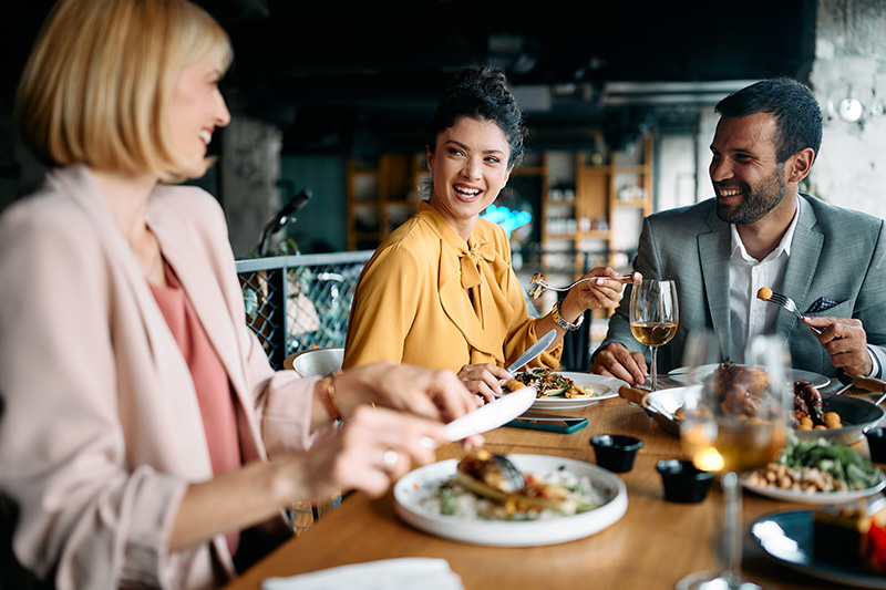 3 people eating a meal at a restaurant