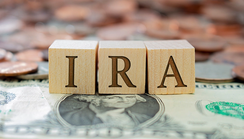 IRA written with blocks on a money background