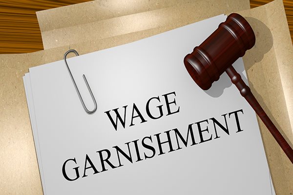 Wage Garnishment written on Paper and Gavel