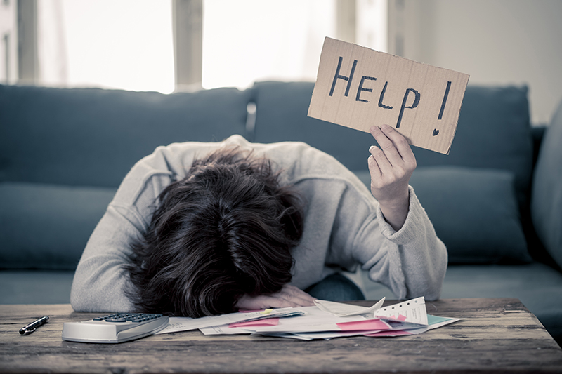 Man holding sign saying HELP!