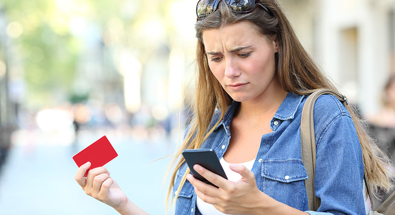 Worried woman looking at her phone