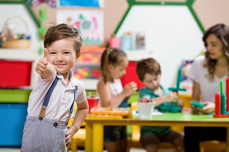 preschool boy with his thumbs up