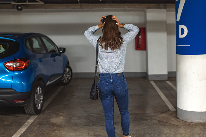 Woman looking in a parking space with her car missing