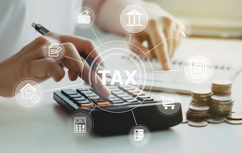 Person typing on calculator with tax graphics overlayed