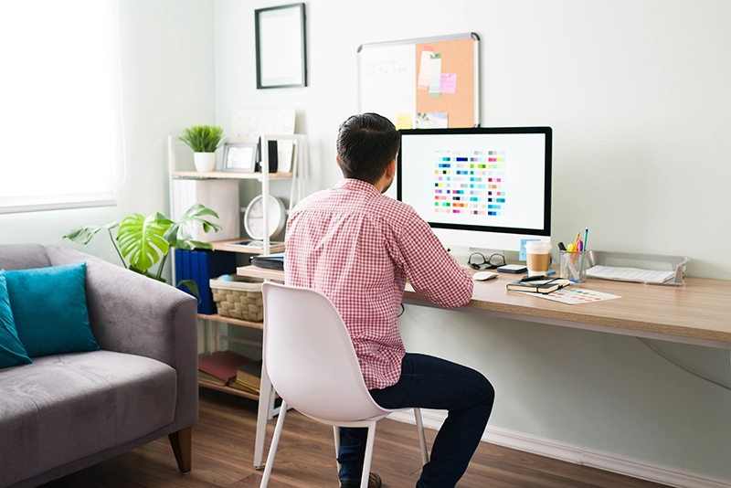 Man working at his desk in his home.