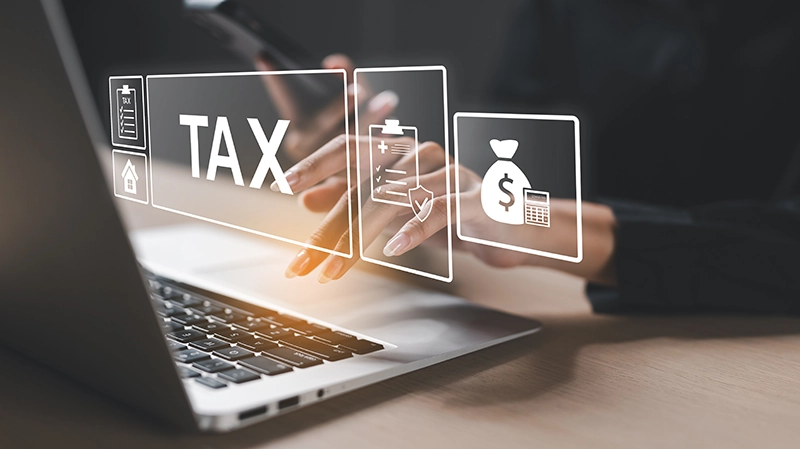 Tax electronic funds graphics floating over a laptop