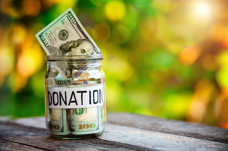 Cash in a jar with Donation labeled on it