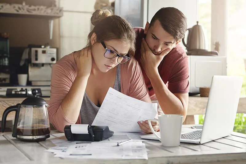 Concerned couple looking over finances
